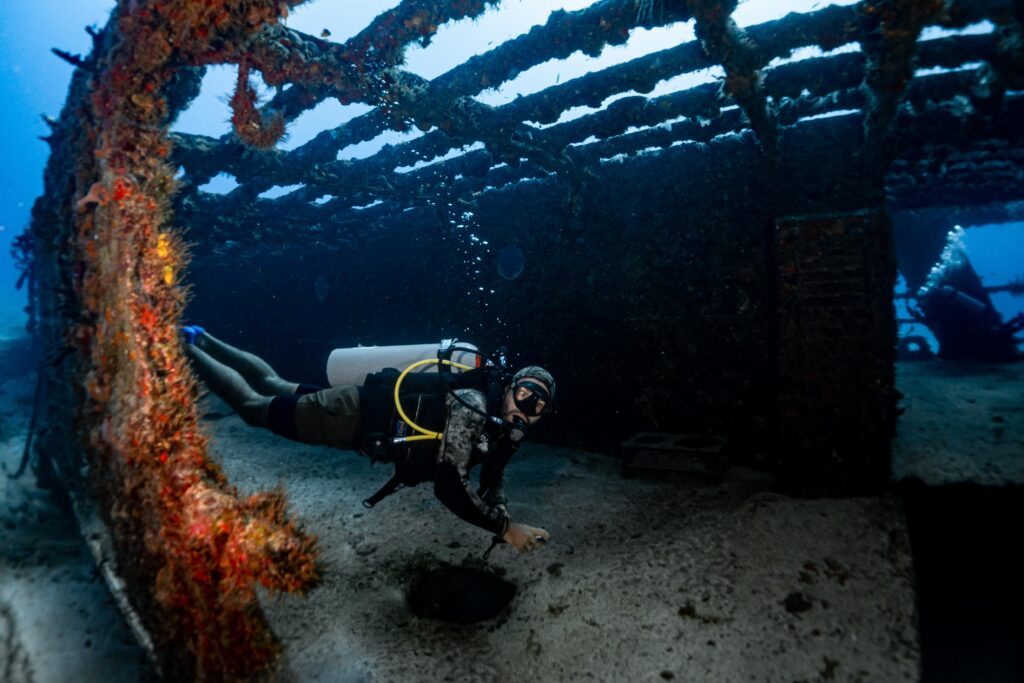 Scuba diver exploring a shipwreck near Puerto Morelos